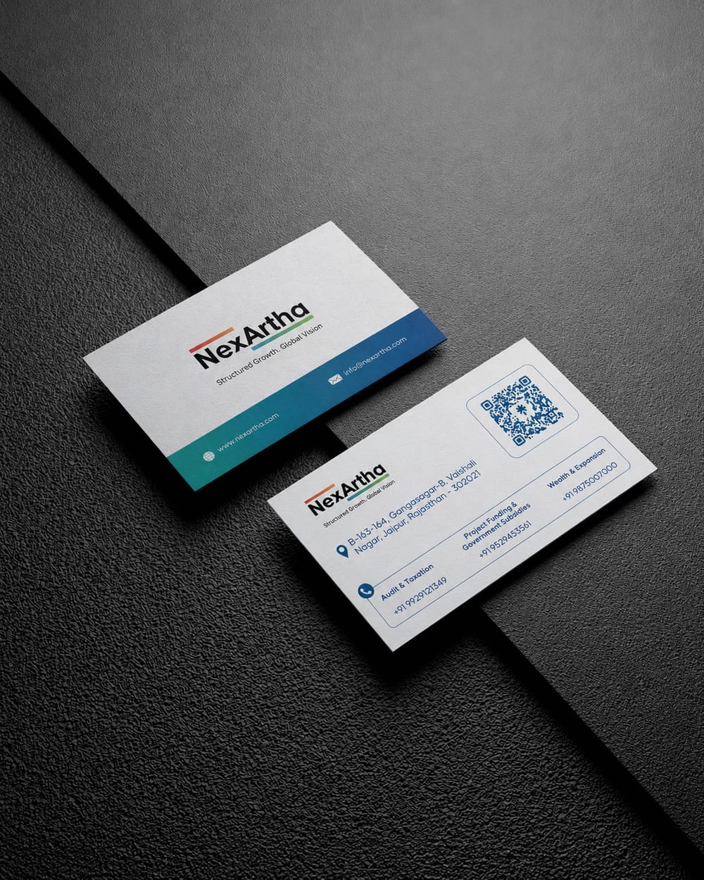 NexArtha business cards, front and back, on a dark textured surface